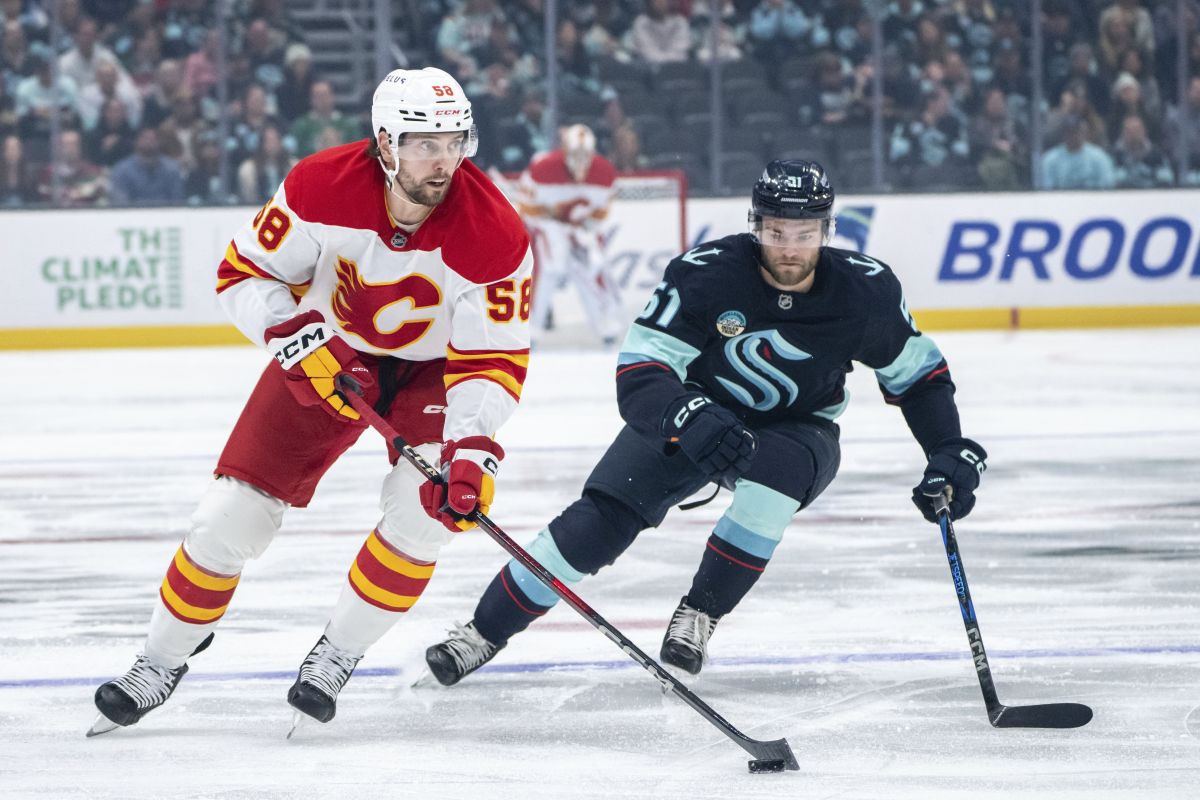 Calgary Flames forward Justin Kirkland skates against Seattle Kraken forward Shane Wright during the first period of an NHL hockey game, Saturday, Oct. 19, 2024, in Seattle.