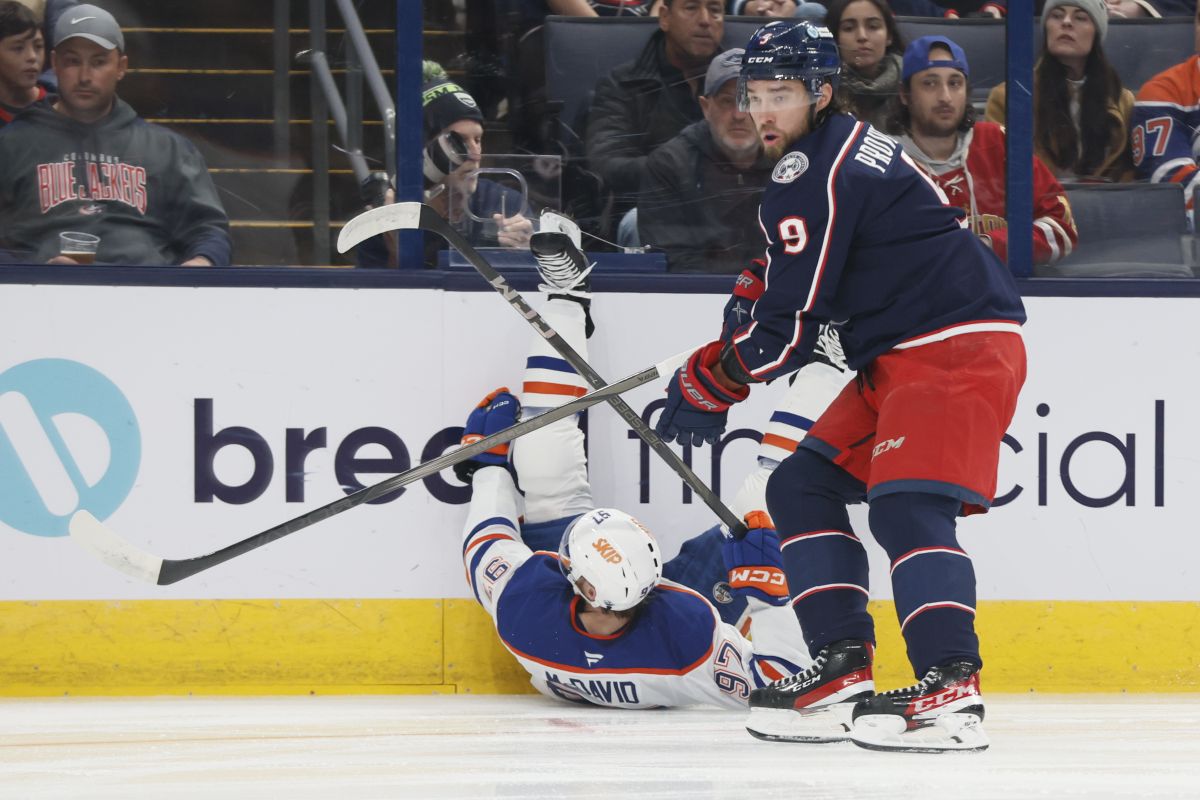 Columbus Blue Jackets' Ivan Provorov, right, knocks Edmonton Oilers' Connor McDavid to the ice during the first period of an NHL hockey game Monday, Oct. 28, 2024, in Columbus, Ohio.