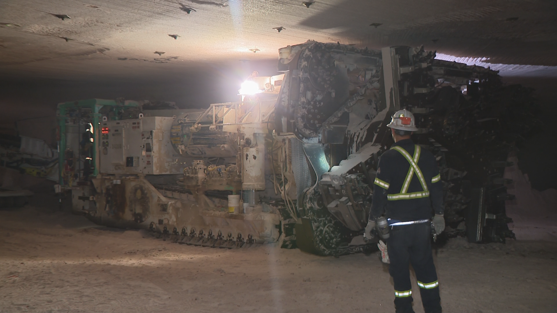 A Nutrien worker helps guide a drill inside the Allan Mine.