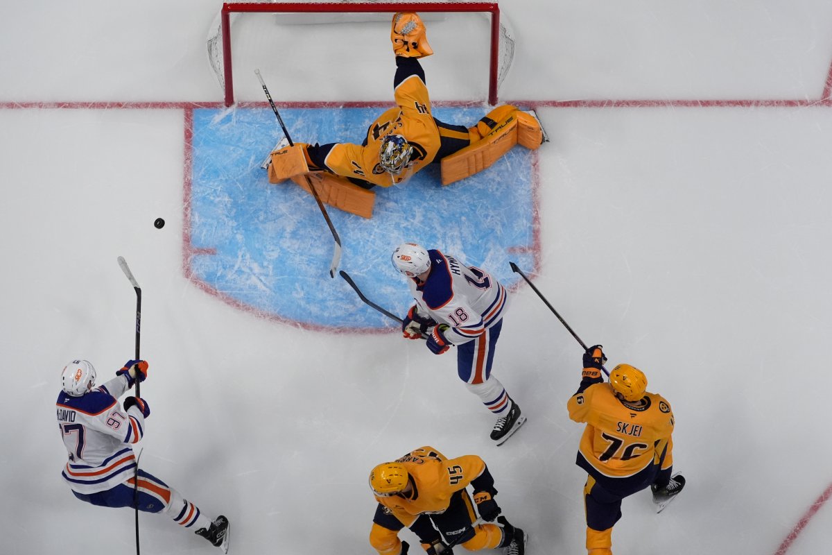 Edmonton Oilers center Connor McDavid (97) scores a goal past Nashville Predators goaltender Juuse Saros (74) during the second period of an NHL hockey game Thursday, Oct. 17, 2024, in Nashville, Tenn.