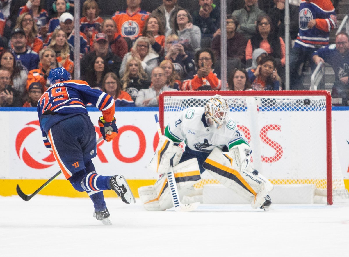 Edmonton Oilers Leon Draisaitl (29) scores on Vancouver Canucks goalie Kevin Lankinen (32) in a shootout during overtime NHL pre-season action in Edmonton on Monday September 30, 2024.