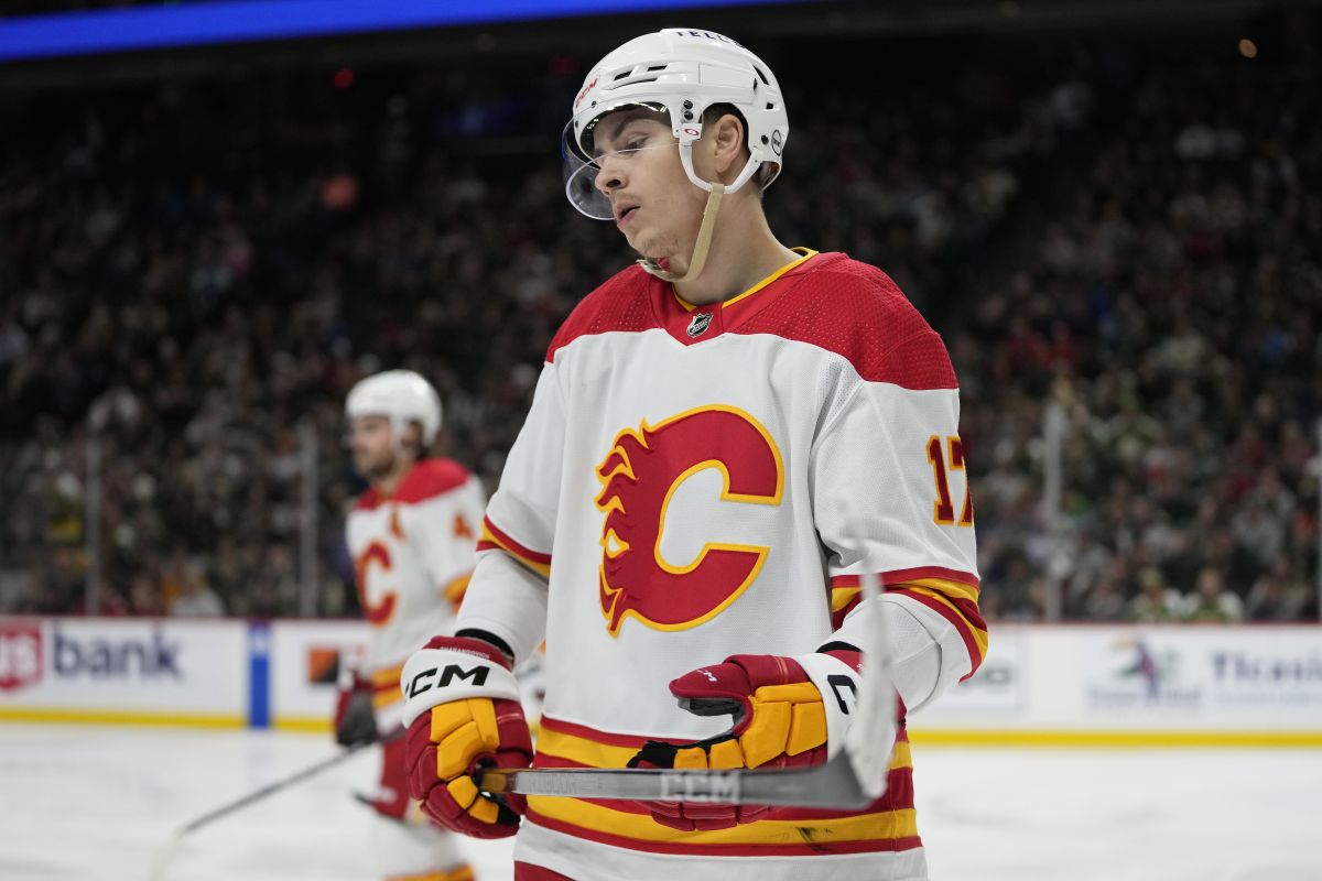 Calgary Flames centre Yegor Sharangovich, front, reacts after a tripping penalty called on the Flames during the third period of an NHL hockey game against the Minnesota Wild, Thursday, Dec. 14, 2023, in St. Paul, Minn.