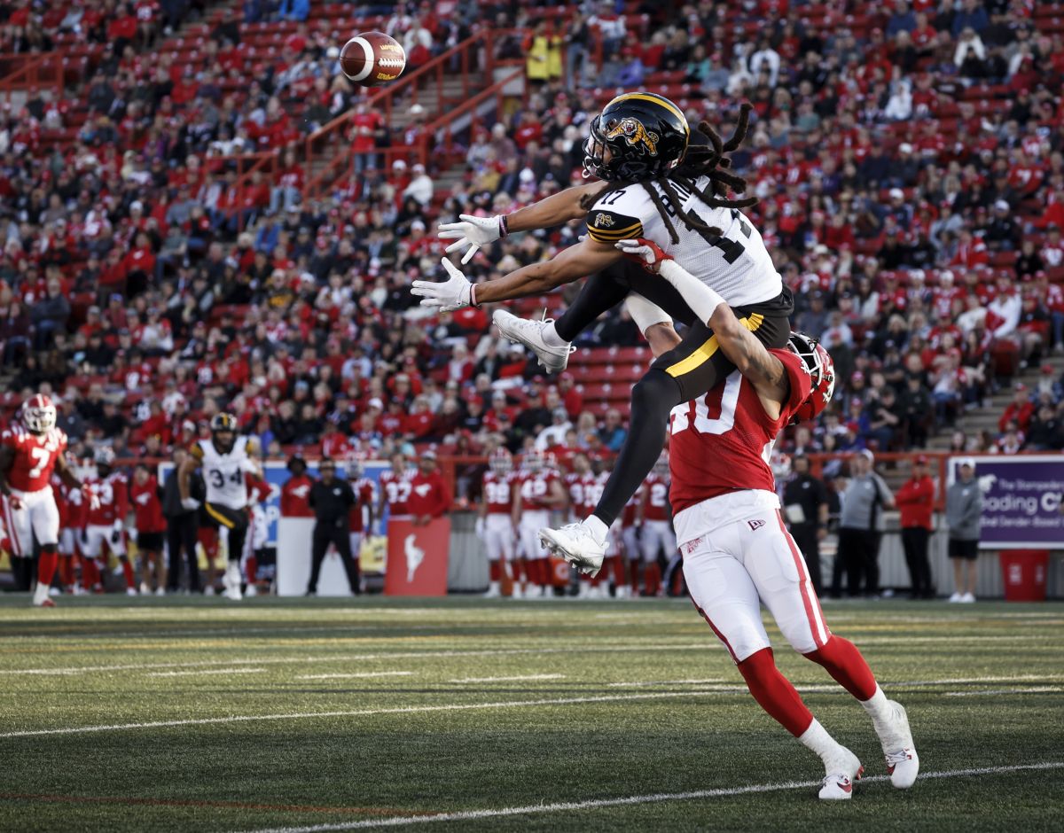 Hamilton Tiger-Cats wide receiver Shemar Bridges (17) goes up for a pass as Calgary Stampeders defensive back Bentlee Sanders (40) hauls him down during second half CFL football action in Calgary, Friday, June 7, 2024.