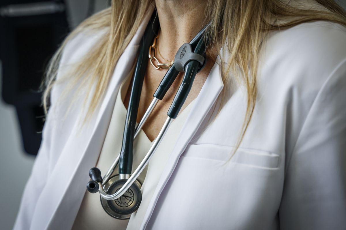 A doctor wears a lab coat and stethoscope in an exam room at a health clinic in Calgary, Alta., Friday, July 14, 2023.