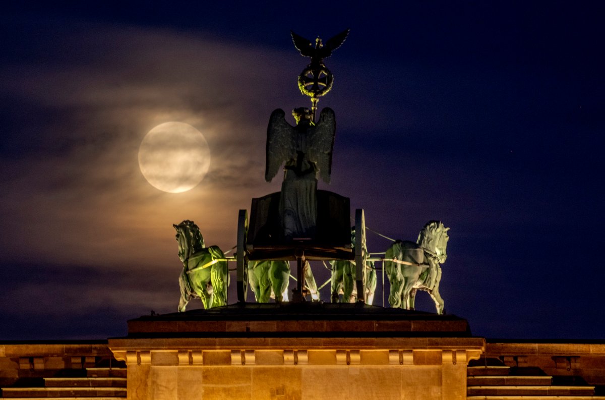 The full Hunters Supermoon rises next to the Quadriga on top of the Brandenburg Gate in Berlin, Germany, Thursday, Oct. 17, 2024. (AP Photo/Michael Probst)