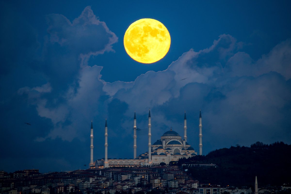 A supermoon rises behind the Camlica mosque in Istanbul, Turkey