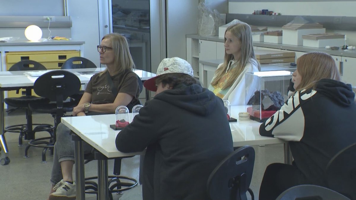 Parents and students listen to a lecture.