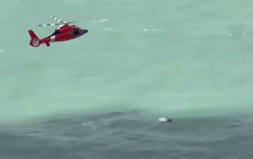 A rescue crew works to save a man spotted clinging to a cooler off the coast of Forida.