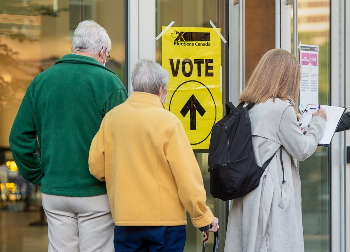 Voters line up at the Halifax Convention Centre as they prepare to vote in the federal election in Halifax on Monday, Sept. 20, 2021. Results of the Halifax municipal election will be known tonight as voters head to the polls to choose their next mayor. THE CANADIAN PRESS/Andrew Vaughan