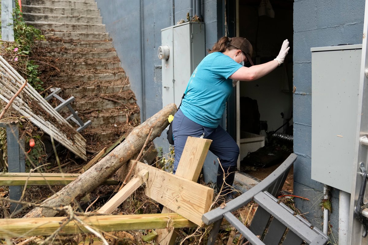 Sarah Calloway enters her restaurant to assess the damage left in the wake of Hurricane Helene Tuesday, Oct. 1, 2024, in Hot Springs, N.C. (AP Photo/Jeff Roberson)