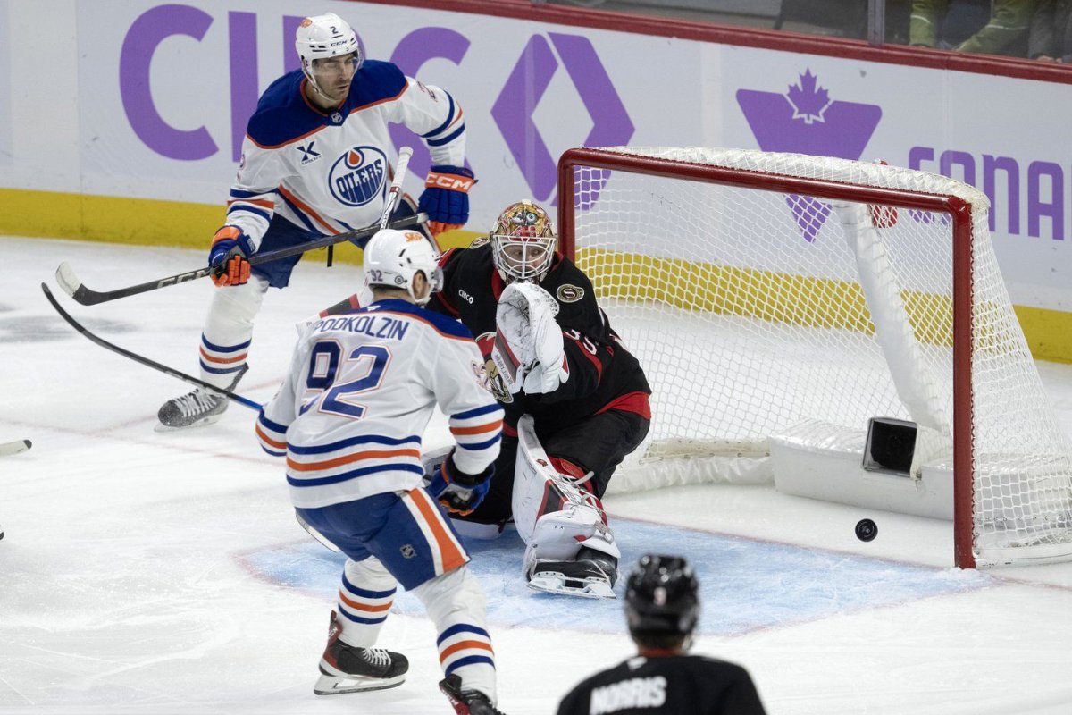 Edmonton Oilers defenceman Evan Bouchard (2) watches the puck bounce around the back of the net after scoring on Ottawa Senators goaltender Linus Ullmark as the Oilers' Vasily Podkolzin looks on during first period NHL action, in Ottawa, Tuesday, Nov. 19, 2024. THE CANADIAN PRESS/Adrian Wyld.