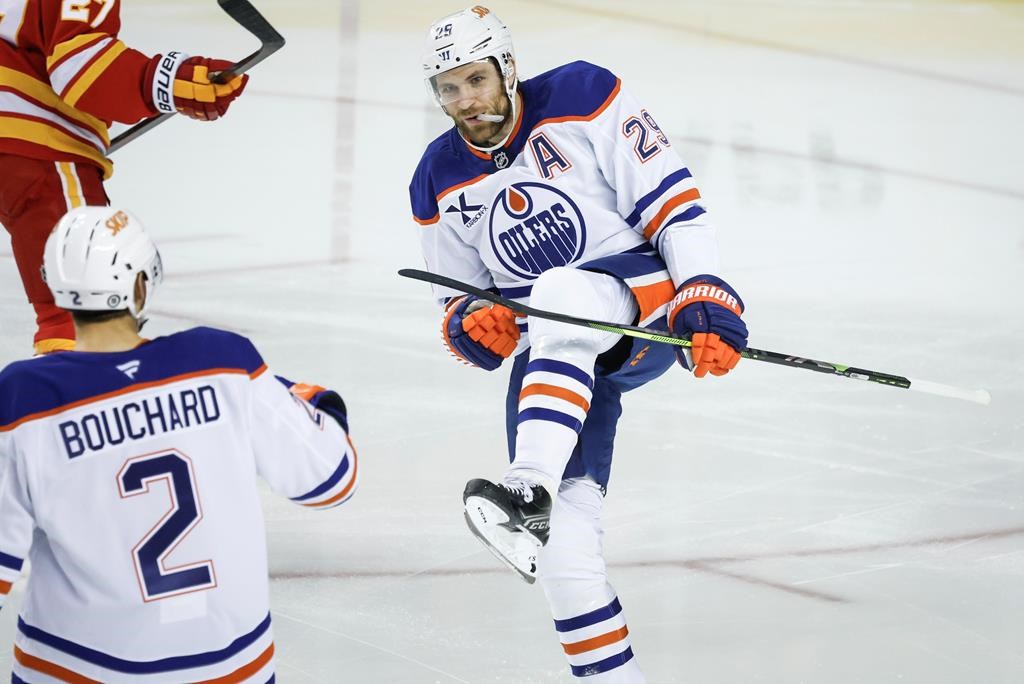 Edmonton Oilers’ Leon Draisaitl, right, celebrates his goal with teammate Evan Bouchard during first period NHL hockey action against the Calgary Flames in Calgary on Sunday, Nov. 3, 2024.