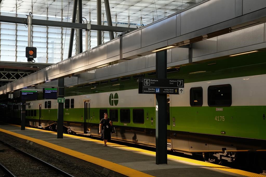 Veterans and Regular Force members of the Canadian Armed Forces will soon be able to ride GO Transit for free. A woman walks along a platform beside a GO train at Toronto's Union Station on Tuesday, Oct. 3, 2023. THE CANADIAN PRESS/Chris Young.