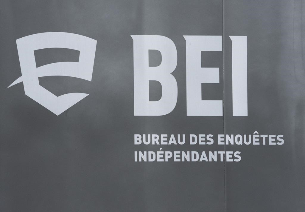 The province's police watchdog is providing some new details about police-involved shooting that left one man dead and a second seriously injured in a remote northern Quebec village. A logo for BEI, Quebec’s independent police bureau, is seen in Louiseville, Que., Tuesday, March 28, 2023. THE CANADIAN PRESS/Ryan Remiorz.