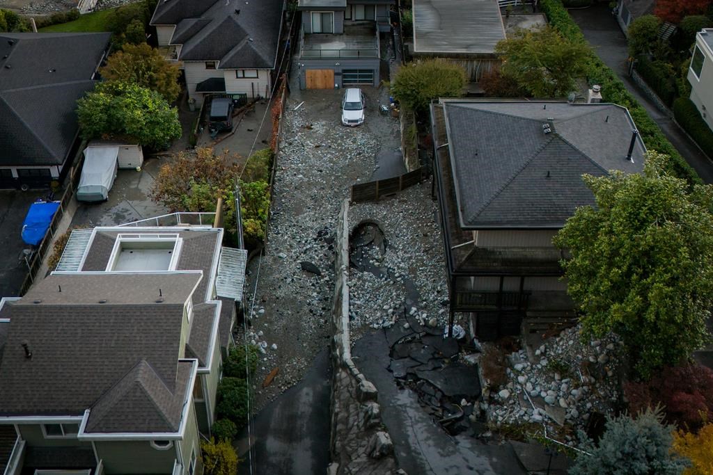 Multiple homes are seen surrounded by debris left by flooding from torrential rain in Deep Cove in North Vancouver, on Oct. 22. 