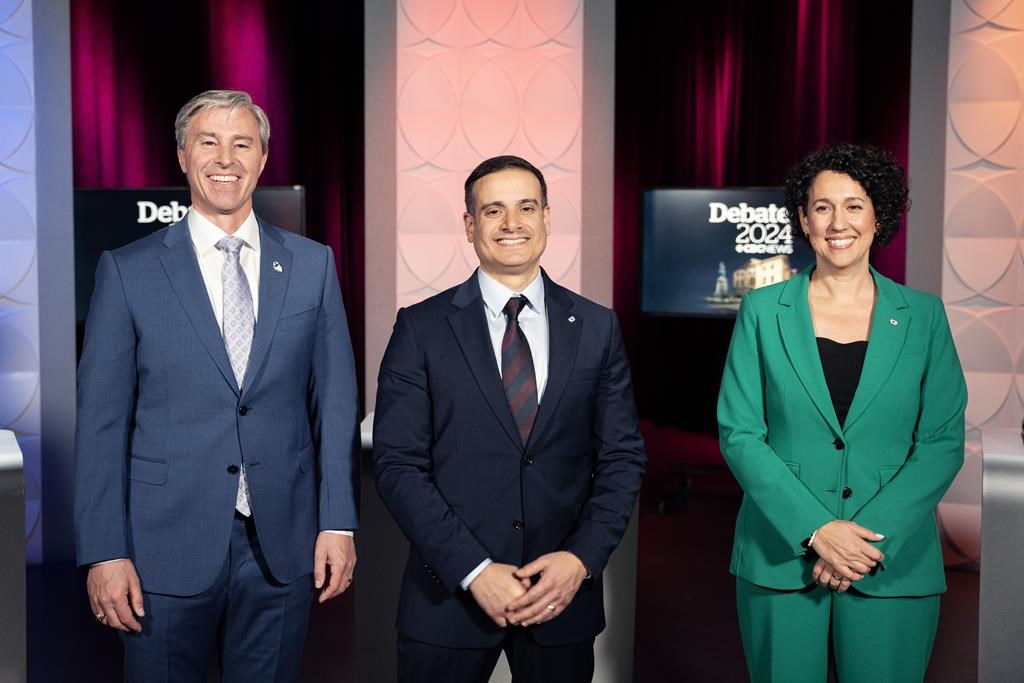 Nova Scotia party leaders, from left to right: Conservative Leader Tim Houston, Liberal Leader Zach Churchill, and NDP Leader Claudia Chender. The leaders pose following a televised debate in Halifax on Thursday, November 14, 2024. THE CANADIAN PRESS/Darren Calabrese.