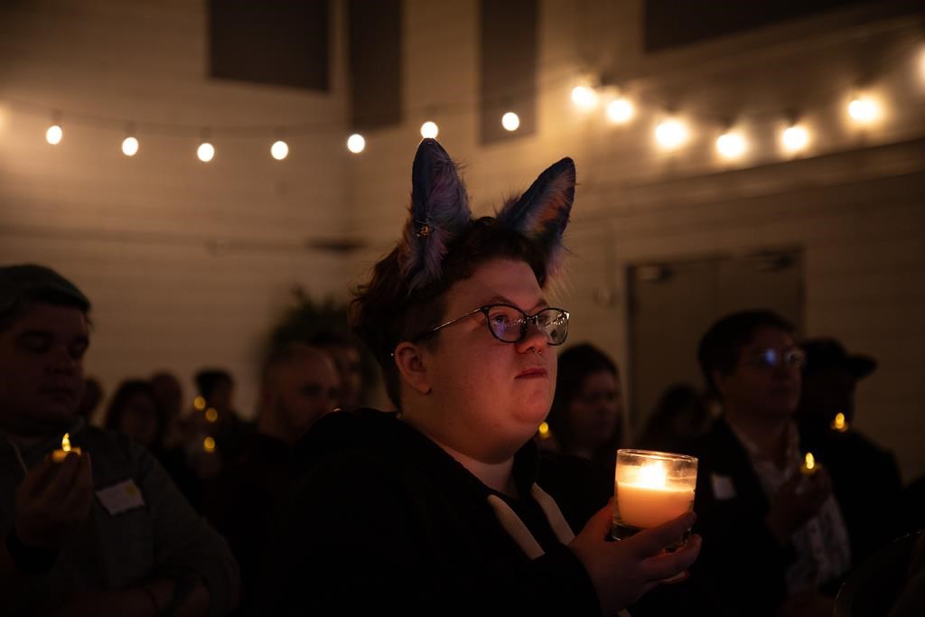 An attendee holds a candle in recognition of trans people who have died during the Trans Day of Remembrance event in Edmonton on Wednesday November 20, 2024.