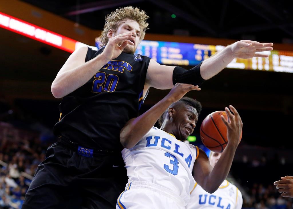 Morehead State’s Chad Posthumus, left, fouls UCLA’s Jordan Adams, right, on a rebound attempt during the first half of a Las Vegas Invitational regional NCAA college basketball game on Nov. 22, 2013, in Los Angeles. THE CANADIAN PRESS/AP/Danny Moloshok