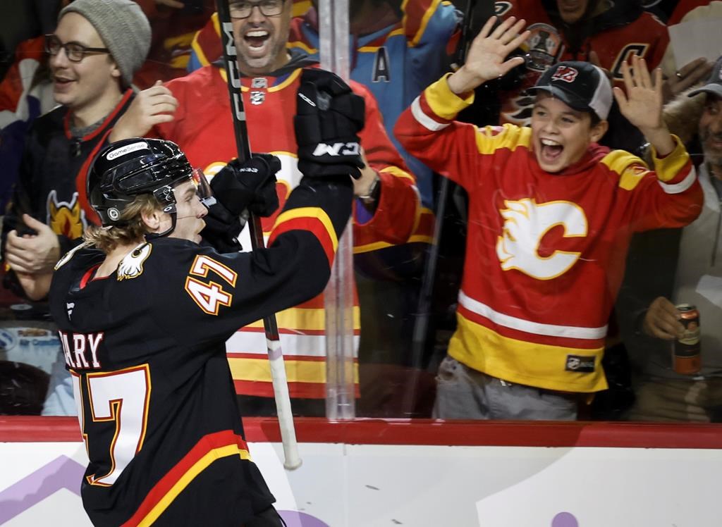 Calgary Flames' Connor Zary, left, celebrates his goal during third period NHL hockey action against the New York Rangers in Calgary on Thursday, Nov. 21, 2024.