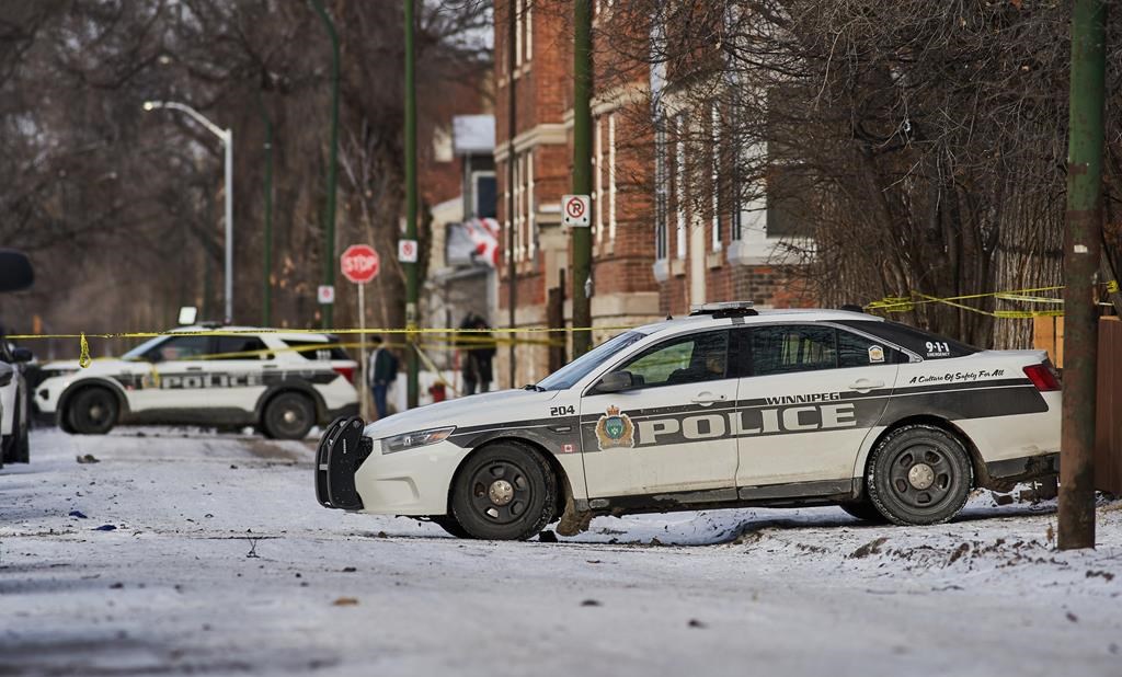 Police secure a crime scene in Winnipeg on Sunday, Nov. 26, 2023.