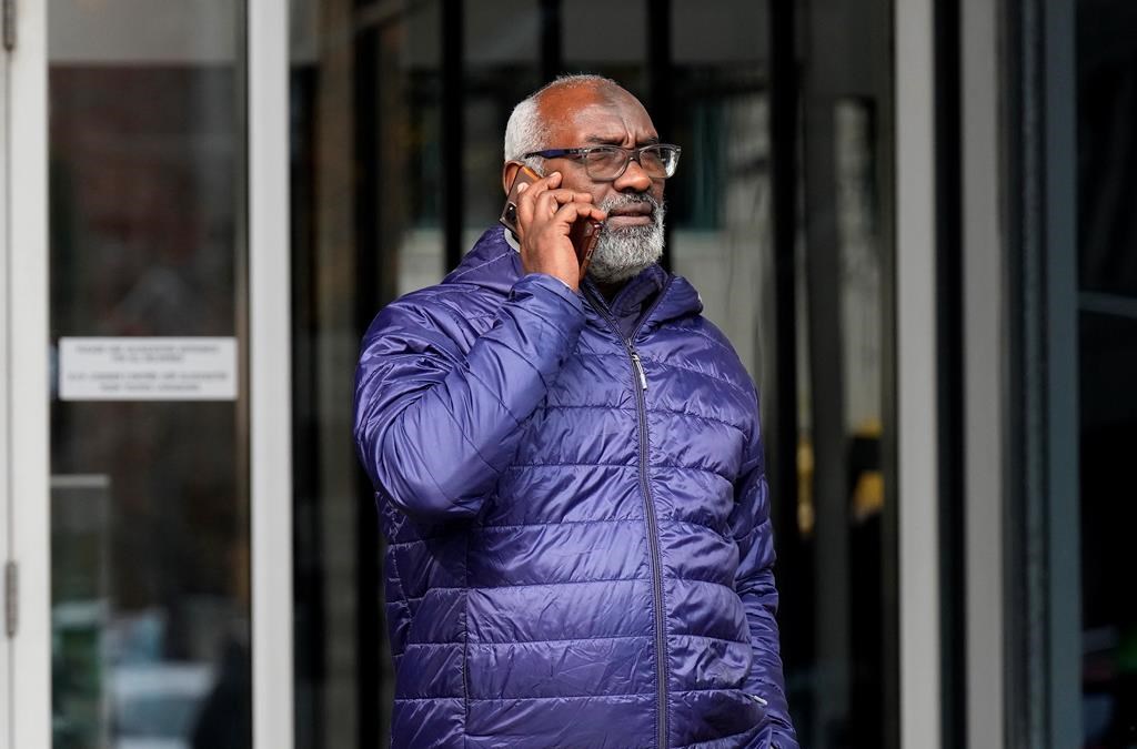 Abousfian Abdelrazik speaks on the phone as he leaves the a building where his case is being heard in Federal Court in Ottawa on October 30, 2024. THE CANADIAN PRESS/Adrian Wyld.