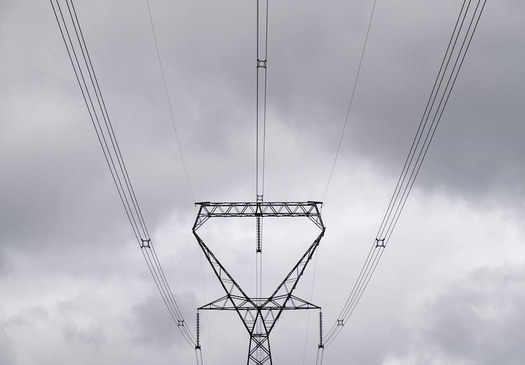 Power lines are seen against cloudy skies near Murvale, Ont. northwest of Kingston, Wednesday, Sept. 7, 2022. THE CANADIAN PRESS/Adrian Wyld.
