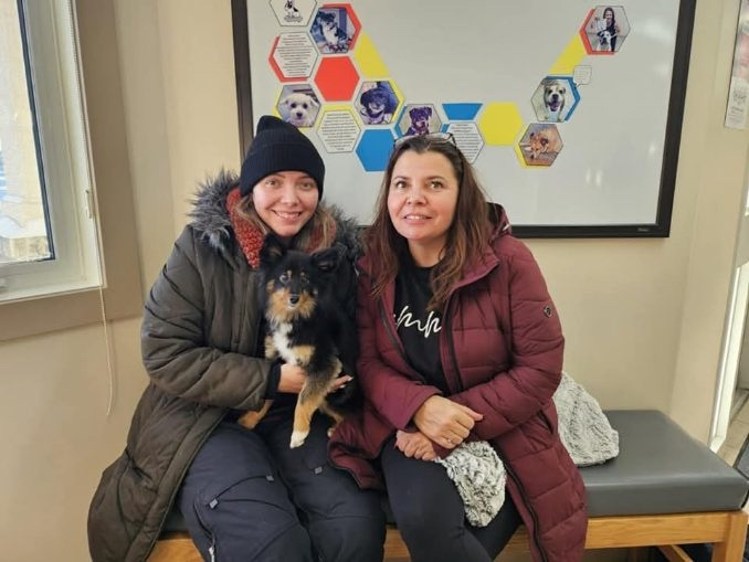 Tamara Fournier and her mother holding Bella at the vet.