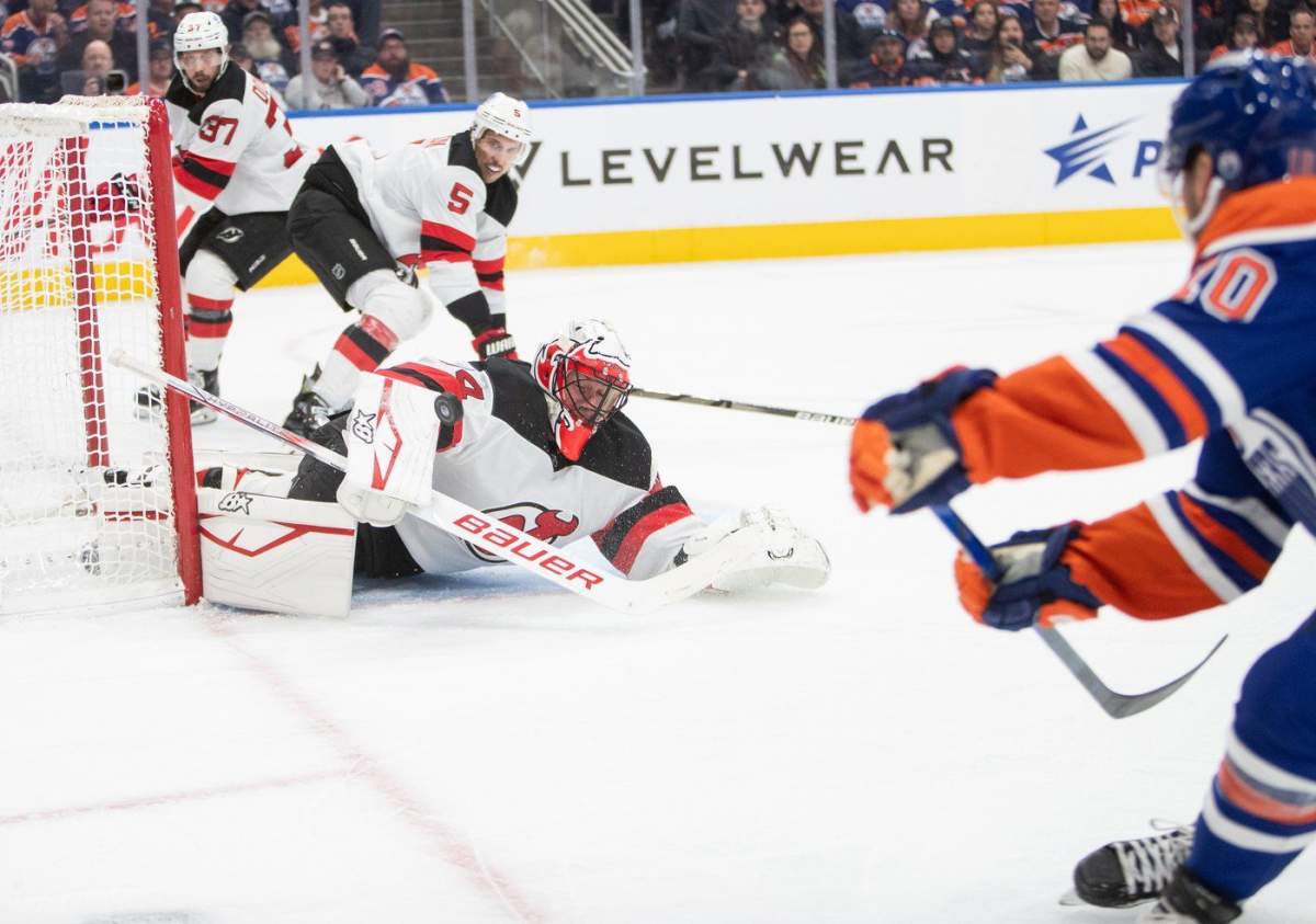 New Jersey Devils goalie Jake Allen (34) keeps out Edmonton Oilers' Derek Ryan's (10) puck as Justin Dowling (37) and Brenden Dillon (5) look on during second period NHL action in Edmonton, Monday, Nov. 4, 2024. THE CANADIAN PRESS/Amber Bracken
AMBER BRACKEN.