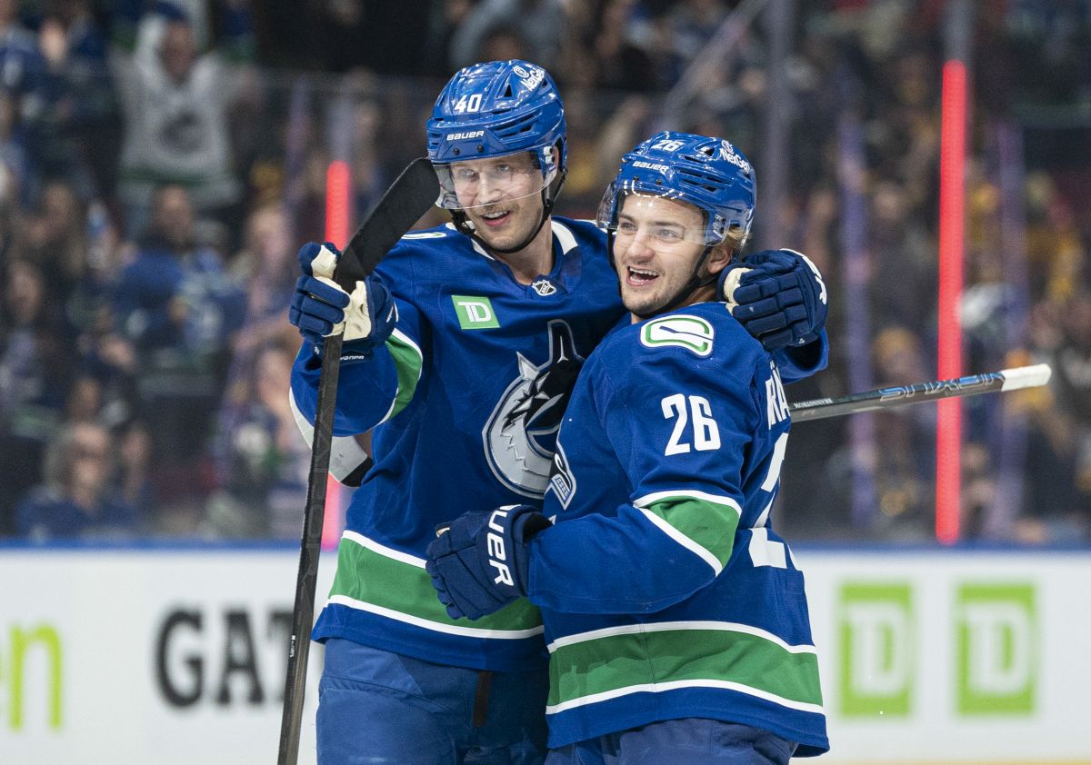 Vancouver Canucks' Erik Brannstrom (right) celebrates with teammate Elias Pettersson after scoring a goal against the Calgary Flames during third period NHL hockey action in Vancouver, B.C., Tuesday, November 12, 2024.