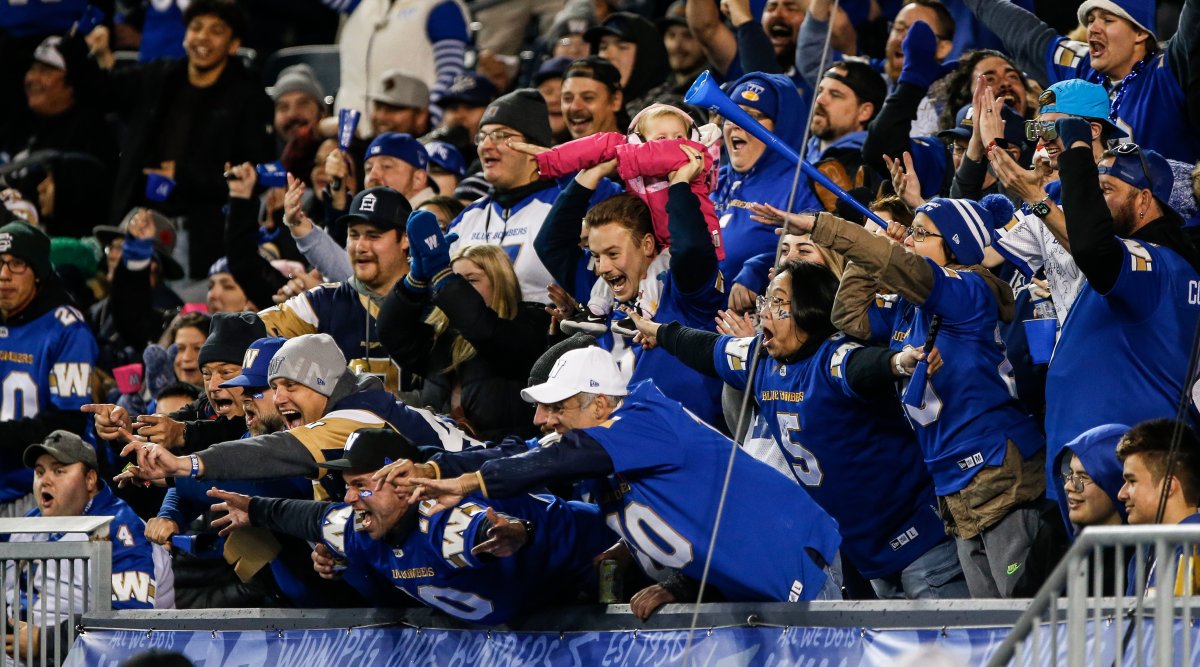 Winnipeg Blue Bombers fans celebrate a touchdown against the Saskatchewan Roughriders during the first half of CFL Western Conference Final action in Winnipeg Saturday, November 9, 2024.    THE CANADIAN PRESS/John Woods.