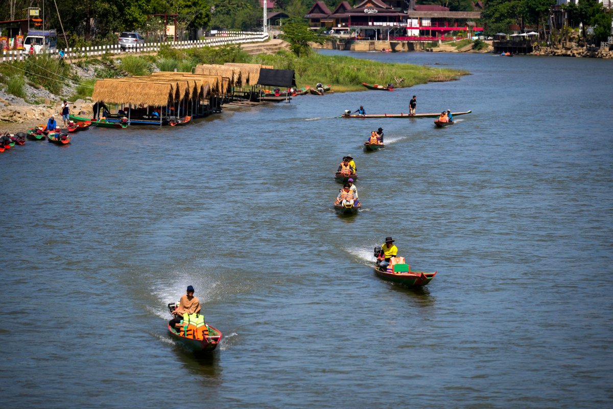 Foreign tourists ride on boats in a river in Vang Vieng, Laos, Friday, Nov. 22, 2024. (AP Photo/Anupam Nath)