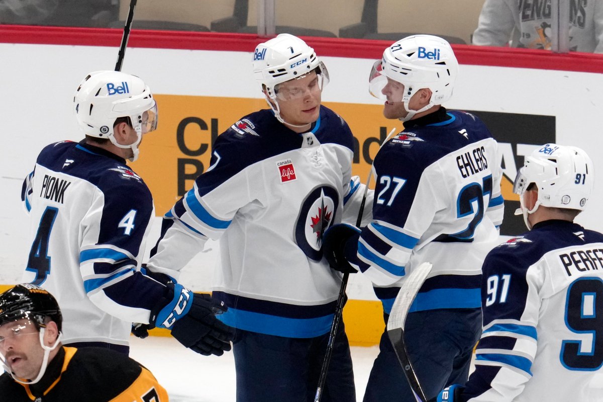 Winnipeg Jets' Vladislav Namestnikov (7) celebrates with Nikolaj Ehlers (27) and Neal Pionk (4) after scoring during the second period of an NHL hockey game against the Pittsburgh Penguins, Friday, Nov. 22, 2024, in Pittsburgh. (AP Photo/Gene J. Puskar).