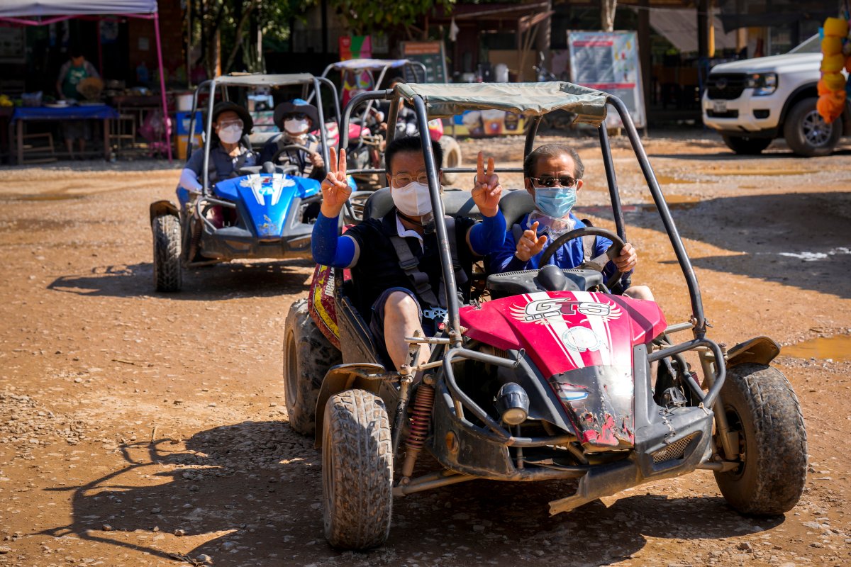 Foreign tourists ride on vehicles in Namsong river in Vang Vieng, Laos, Saturday, Nov. 23, 2024. (AP Photo/Anupam Nath)