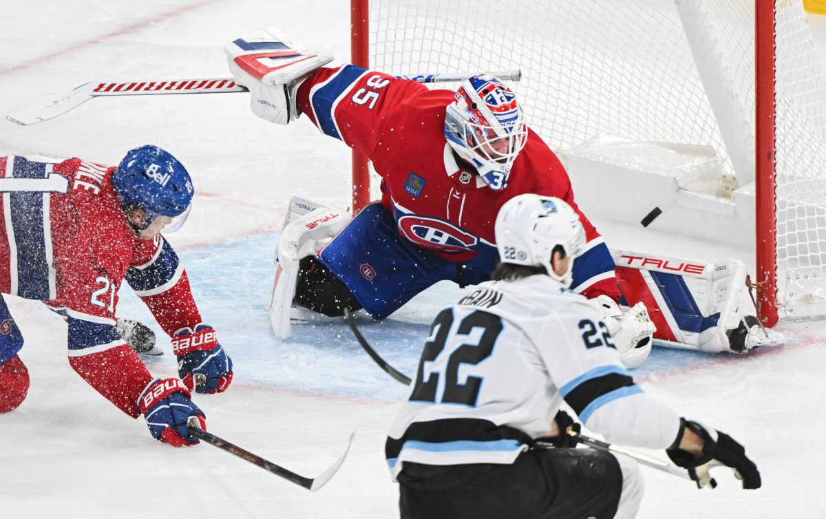 Utah Hockey Club's Jack McBain (22) scores against Montreal Canadiens goaltender Sam Montembeault as Canadiens' Kaiden Guhle (21) defends during third period NHL hockey action in Montreal, Tuesday, November 26, 2024. THE CANADIAN PRESS/Graham Hughes.