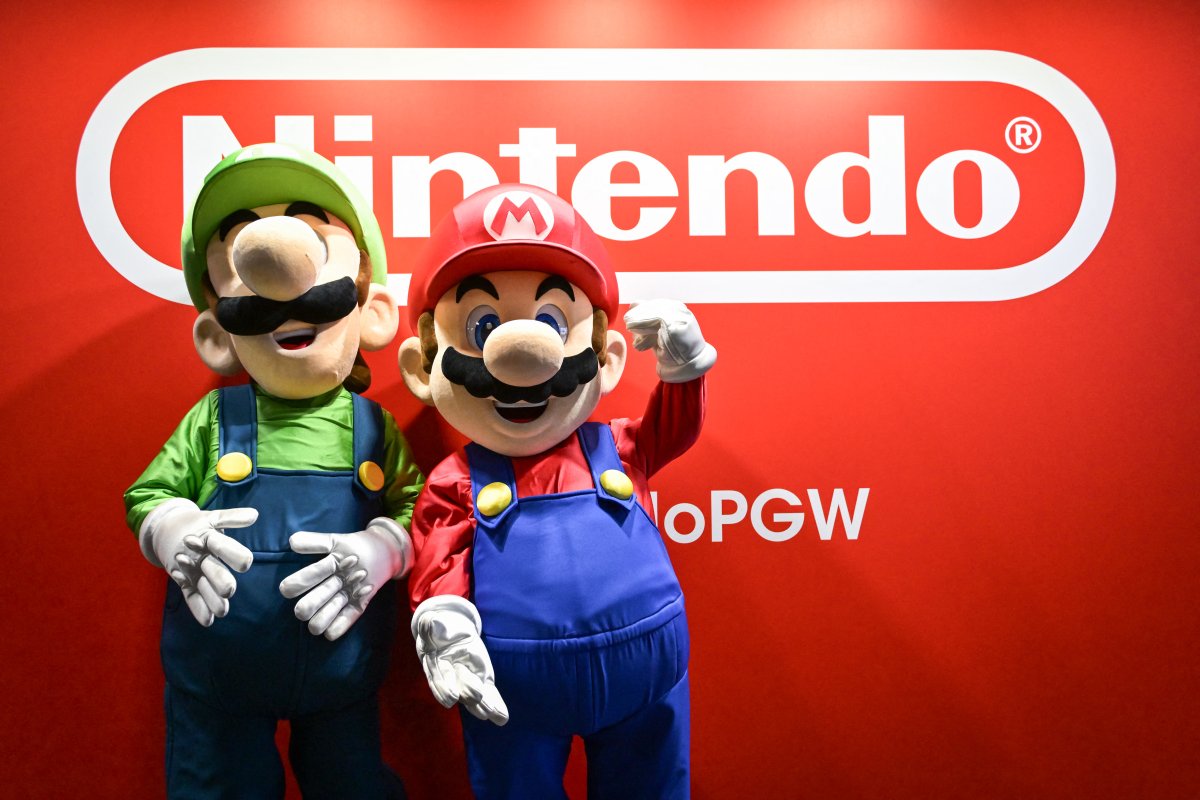 Participants wearing Mario and Luigi mascots pose for a photo next to Nintendo logo during the Paris Game Week 2024 event at the Parc des expositions in Paris on October 24, 2024. Photo by Firas Abdullah/ABACAPRESS.COM