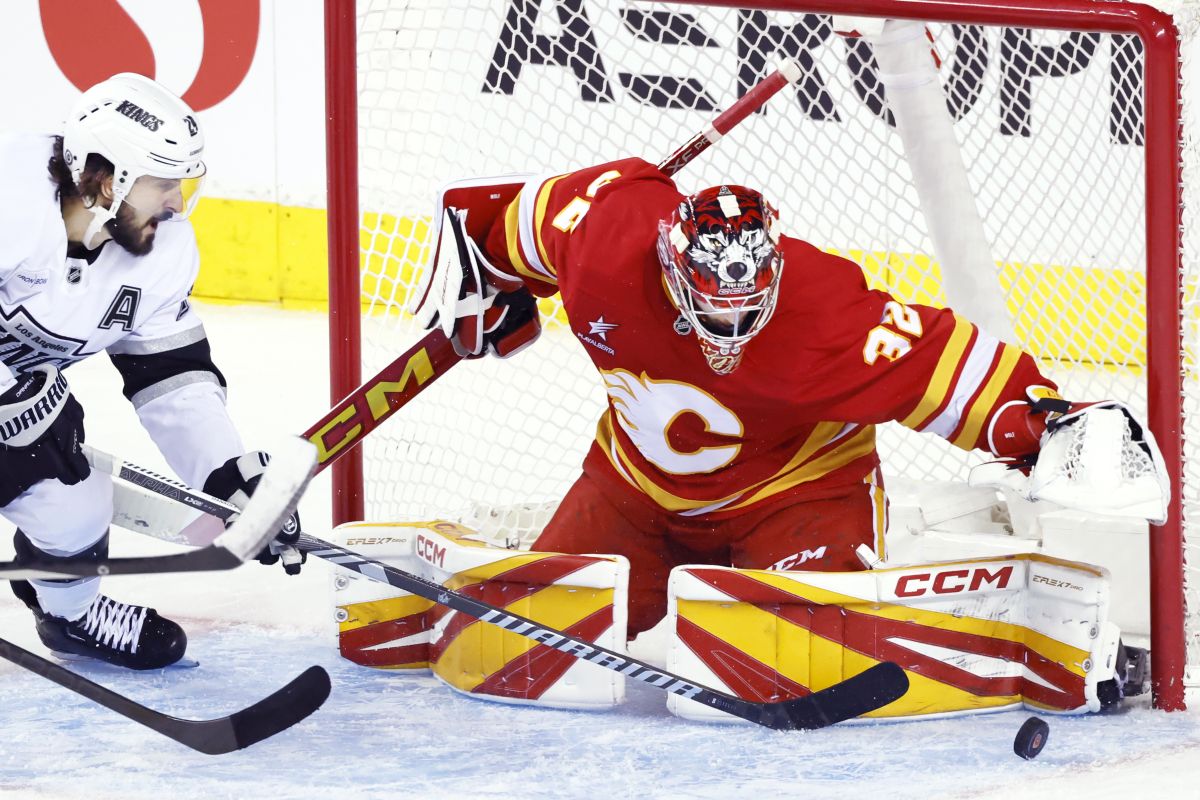 Calgary Flames goalie Dustin Wolf (32) stops a shot by Los Angeles Kings' Phillip Danault during third period NHL hockey action in Calgary, Alta., Monday, Nov. 11, 2024.