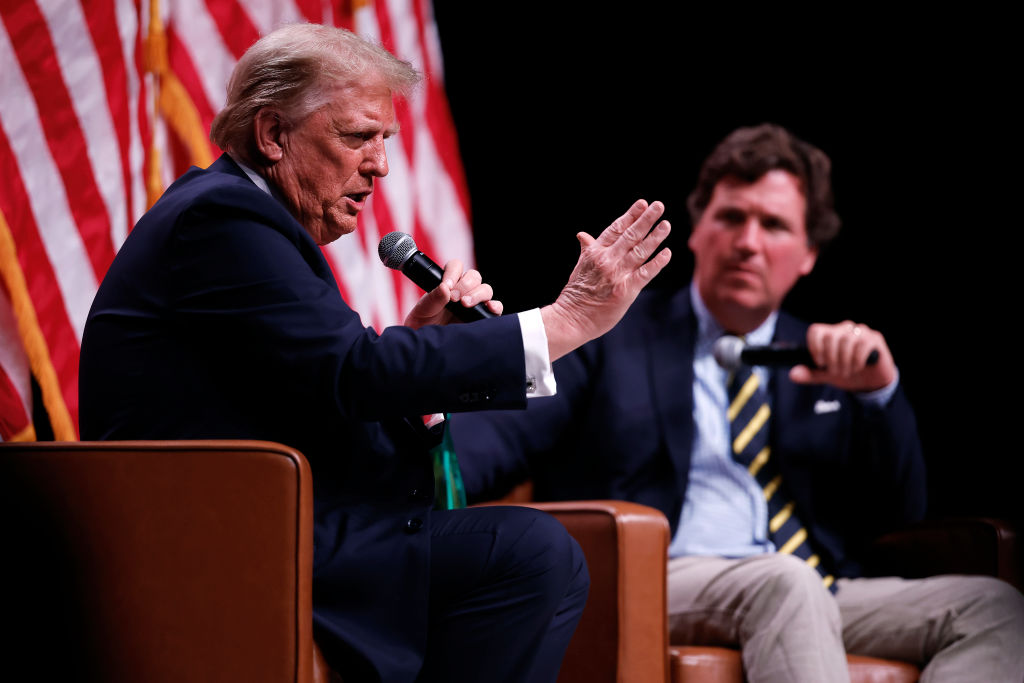 Republican presidential nominee, former President Donald Trump sits down for a conversation with Tucker Carlson during his Live Tour at the Desert Diamond Arena on October 31, 2024 in Phoenix, Arizona. With less than a week until Election Day, Trump is campaigning for re-election in New Mexico and the battleground states of Nevada and Arizona on Thursday.