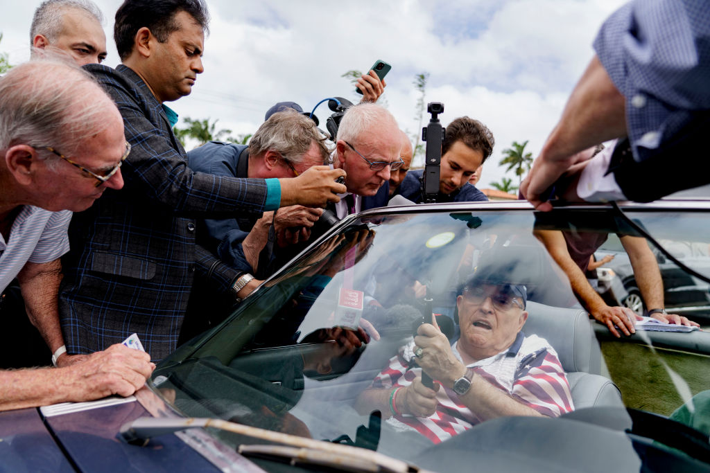 Rudy Giuliani, former lawyer to former US President Donald Trump, center, speaks to members of the media outside a polling location for the 2024 Presidential election at the Mandel Community Center in Palm Beach, Florida, on Tuesday, Nov. 5, 2024.