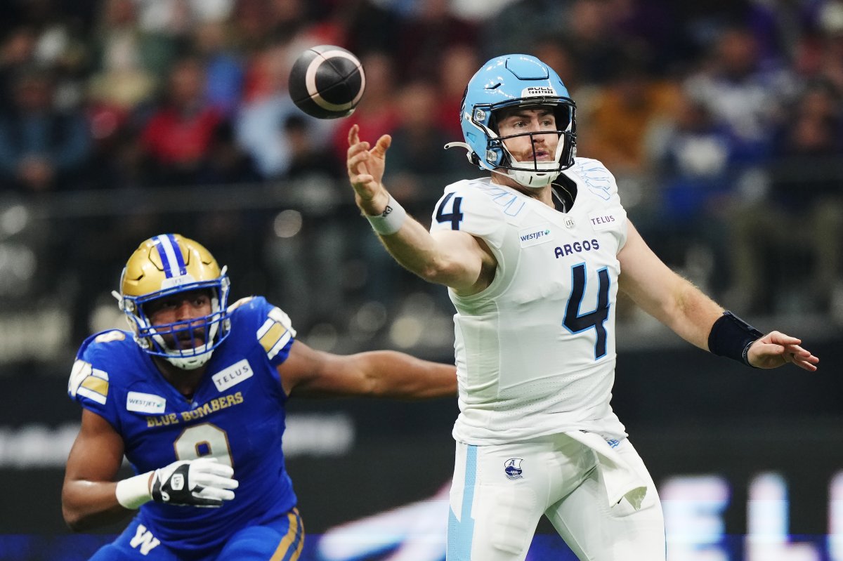 Toronto Argonauts quarterback Nick Arbuckle (4) passes as Winnipeg Blue Bombers' TyJuan Garbutt (9) chases during first half CFL football action at the 111th Grey Cup in Vancouver on Sunday, November 17, 2024.