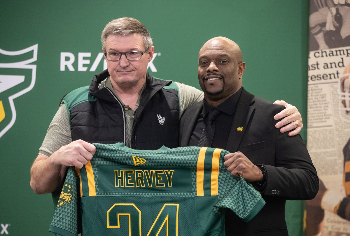 President and CEO for the Edmonton Elks Chris Morris presents a jersey to Ed Hervey after being named Edmonton Elks Vice President of Football Operations and General Manager in Edmonton, Wednesday, Nov. 20, 2024.
