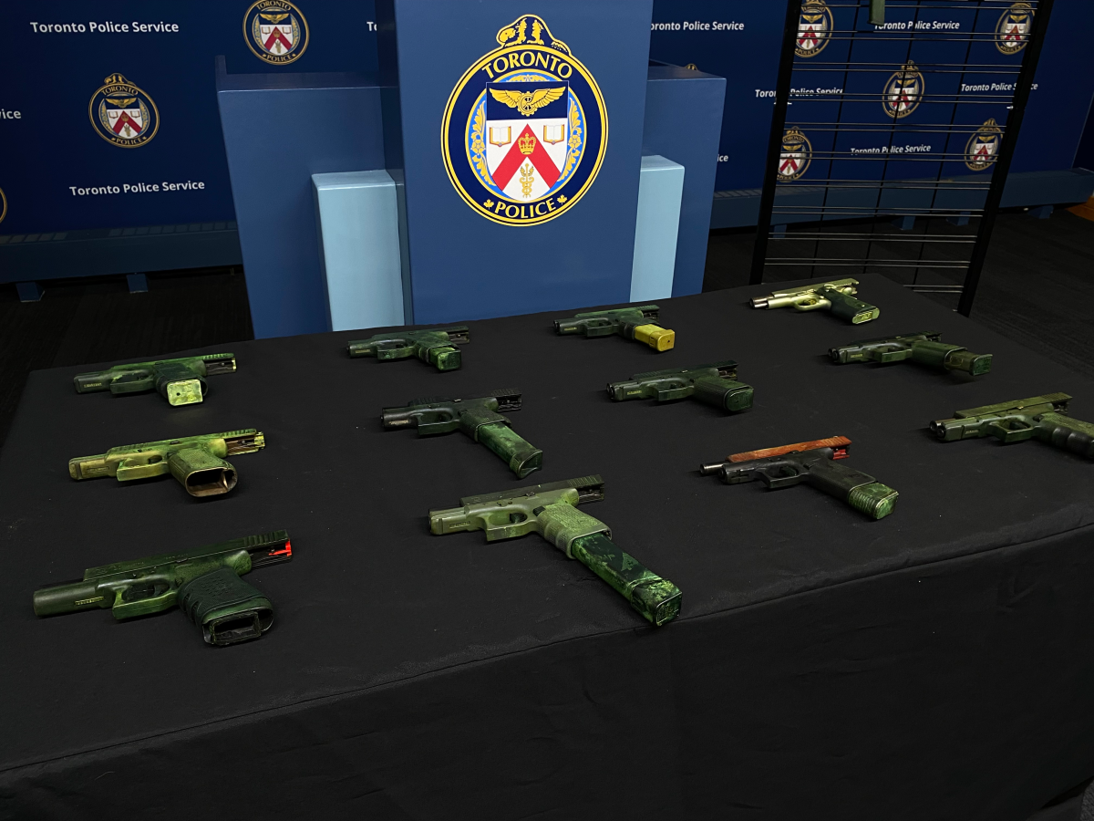 Firearms seized from a brazen exchange of gunfire and on display at a press conference at Toronto police headquarters on Nov. 14, 2024.