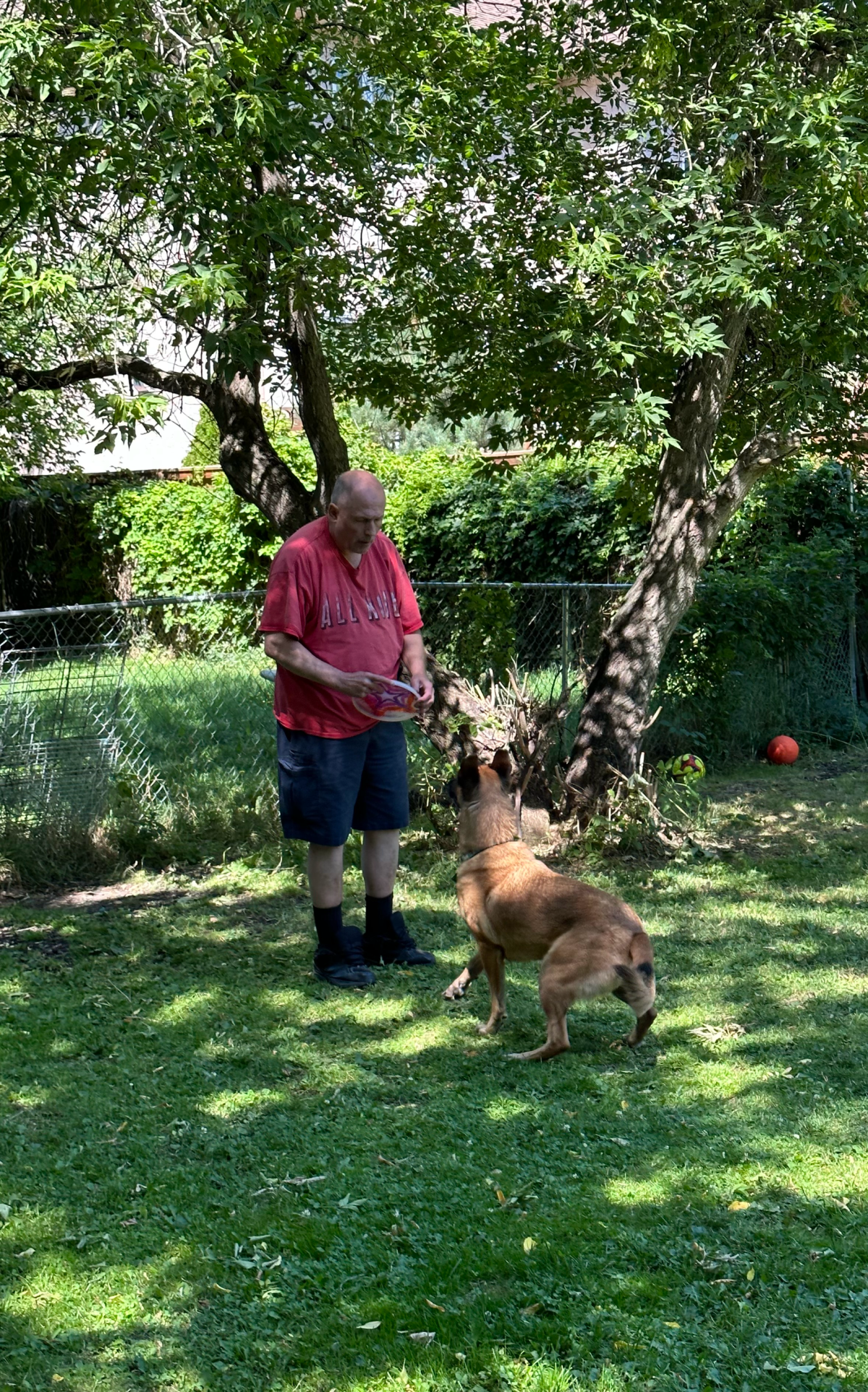 Craig Schaefer plays with a dog.