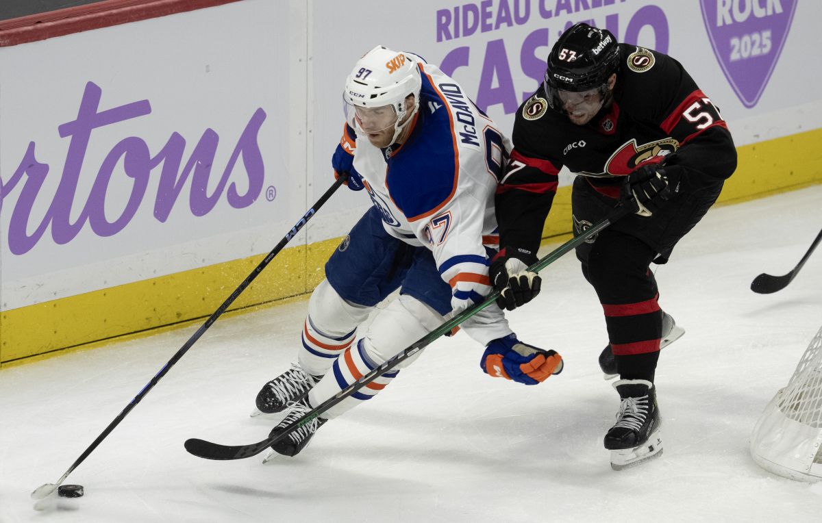 Edmonton Oilers centre Connor McDavid (97) fights off Ottawa Senators left wing David Perron (57) as he skates behind the net with the puck during third period NHL action in Ottawa, Tuesday, Nov. 19, 2024. The Oilers defeated the Senators 5-2.