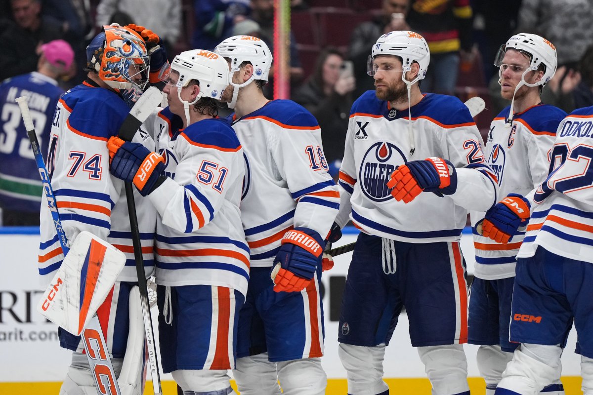 Edmonton Oilers goalie Stuart Skinner, from left to right, Troy Stecher, Zach Hyman, Leon Draisaitl and Connor McDavid celebrate after Edmonton defeated the Vancouver Canucks 7-3 during an NHL hockey game in Vancouver, on Saturday, November 9, 2024.