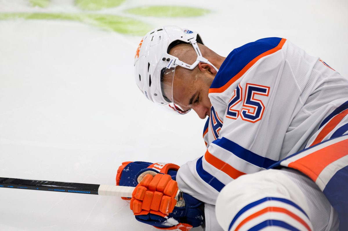 Edmonton Oilers defenceman Darnell Nurse (25) lays on the ice after colliding with Toronto Maple Leafs right wing Ryan Reaves (75) during second period NHL hockey action, in Toronto, Saturday, Nov. 16, 2024.