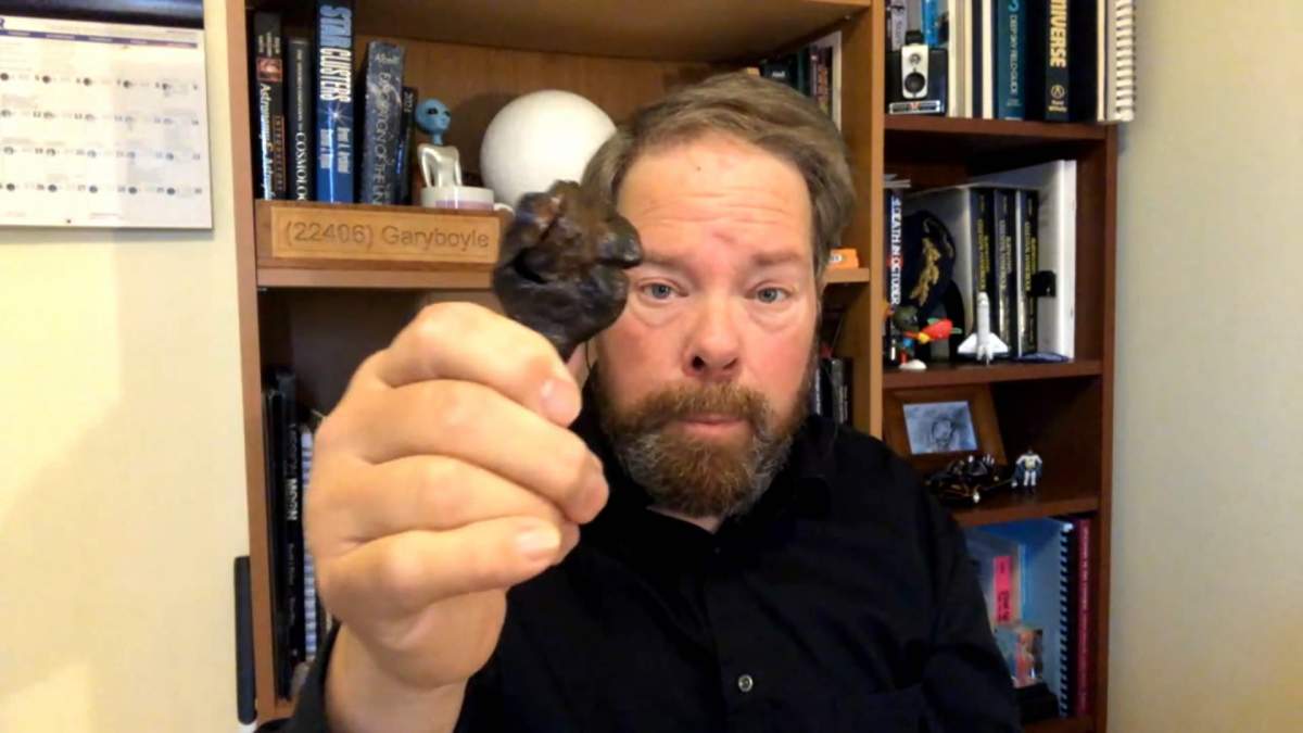 Gary Boyle, "The Backyard Astronomer" holds a sample of a meteorite that was big enough to survive its plunge through the earth's atmosphere.