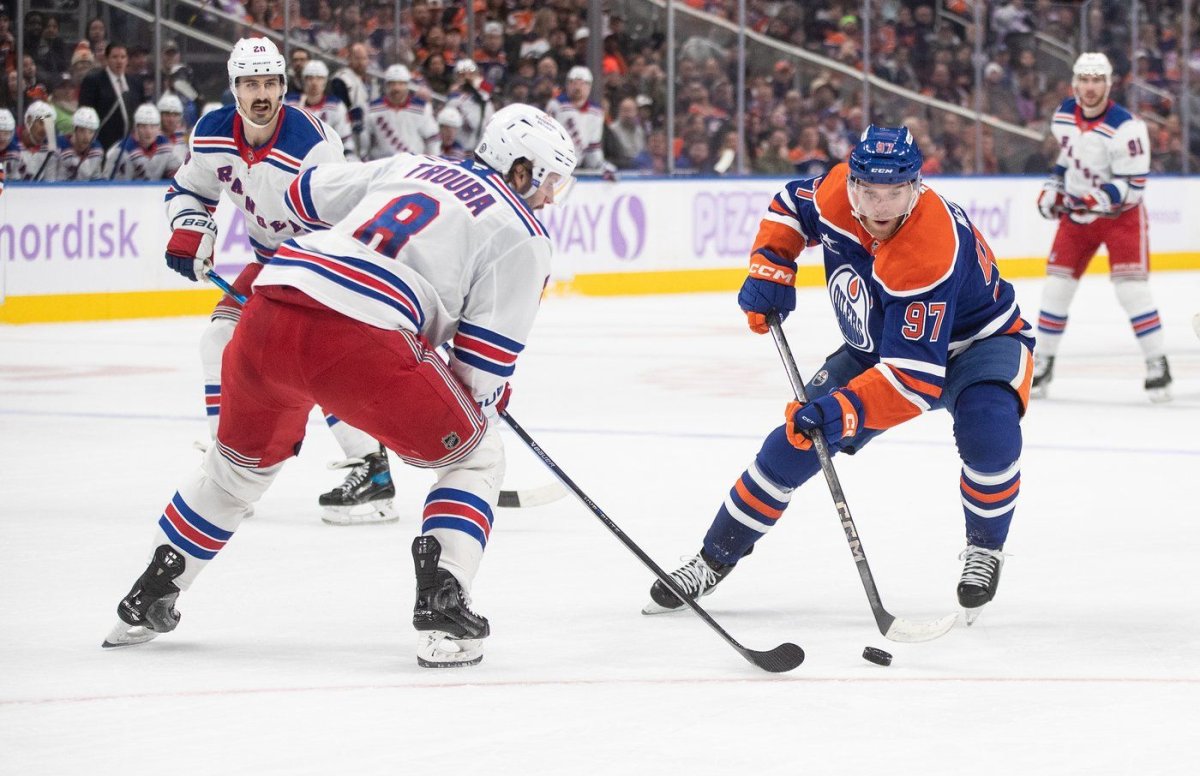 New York Rangers' Jacob Trouba (8) tries to defend against Edmonton Oilers' Connor McDavid (97) during second period NHL action in Edmonton on Saturday, November 23, 2024. THE CANADIAN PRESS/Jason Franson
JASON FRANSON.