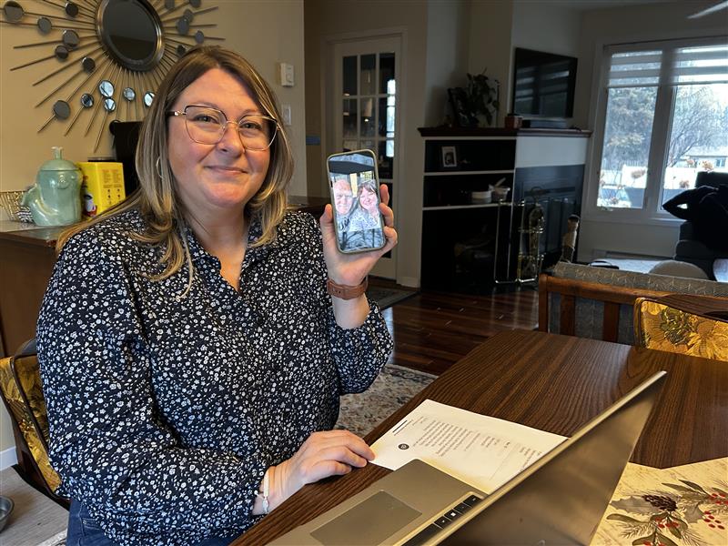 Emily holds a picture of her father.