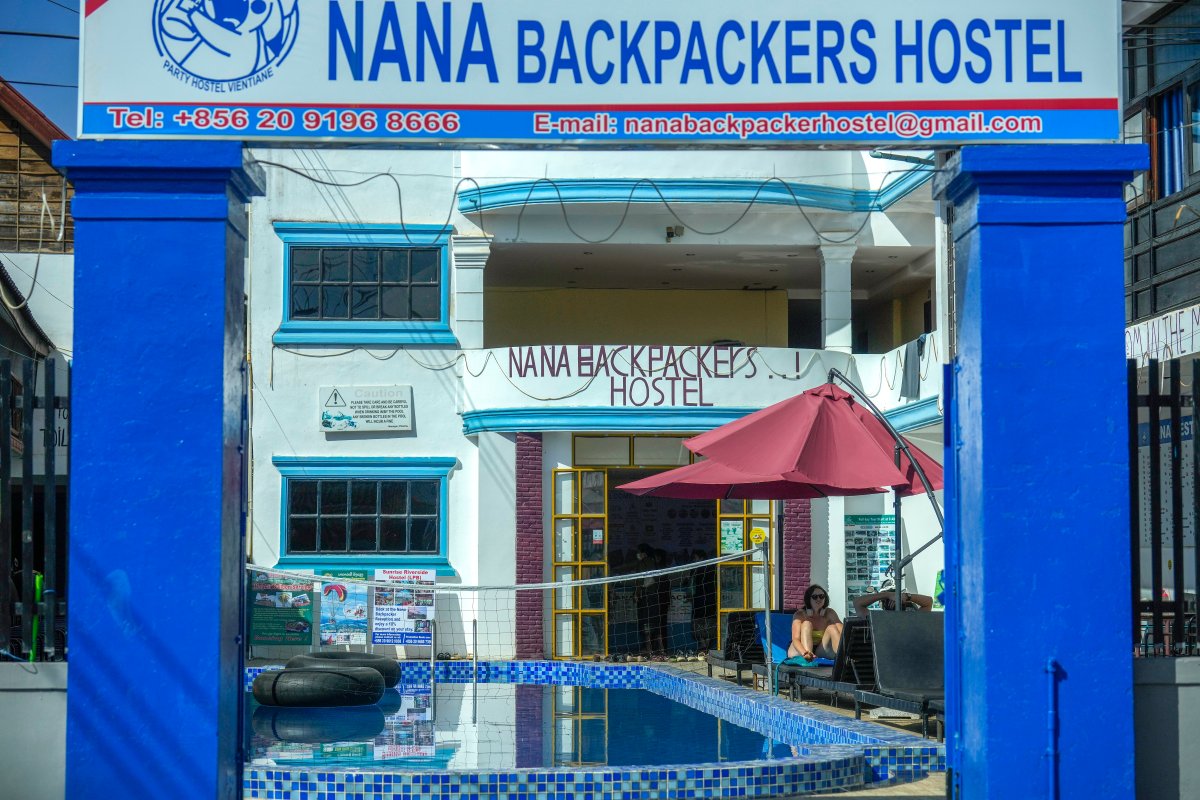 A foreign tourist couple rest near a swimming pool at Nana Backpackers hostel in Vang Vieng, Laos, Nov. 22, 2024.