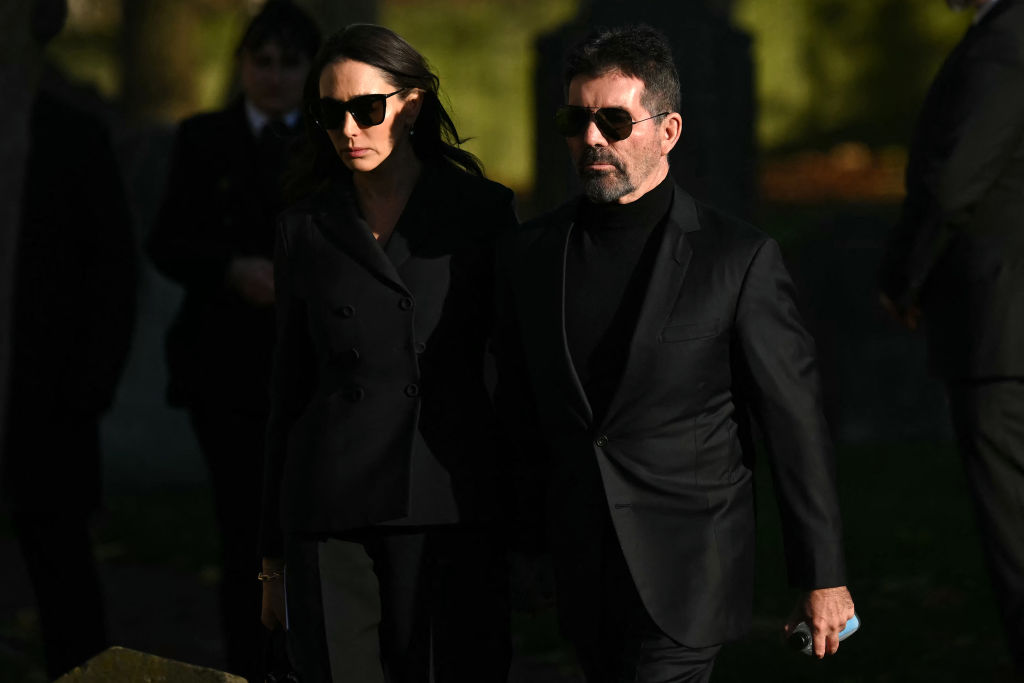Simon Cowell (R) and Lauren Silverman leave after attending the funeral service of the late One Direction singer Liam Payne, at a St Mary's church in Amersham, west of London on November 20, 2024.